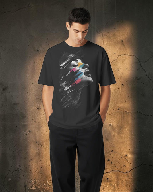 Bold Bazar black oversized cotton t-shirt featuring an abstract face print with pink, teal, and yellow brushstrokes.